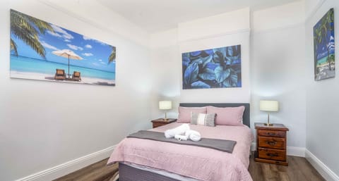 Main bedroom, looking out onto Summer street with built in wardrobe.