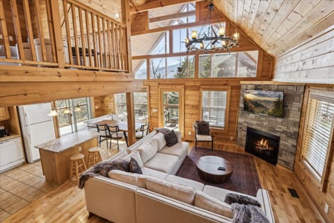 Cozy up in this spacious living room! Soaring vaulted ceilings with fireplace.