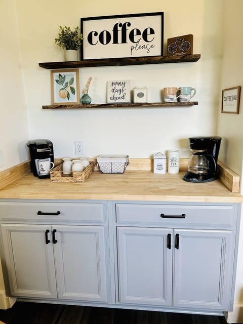 Our coffee bar is stocked with a Kuerig, coffee maker, tea, and coffee grounds.