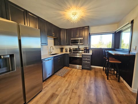 Kitchen with bar top seating for 2 with a view of the harbor