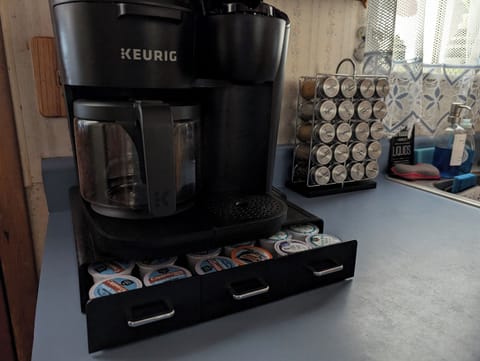 Keurig coffee pot with single cups or you can make pot. Spice rack.