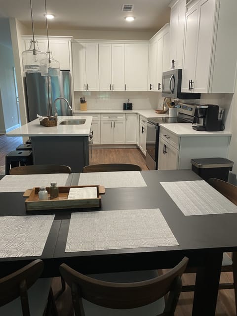 Kitchen table set up to seat 6. Leaf under master bed to allow seating for 8.