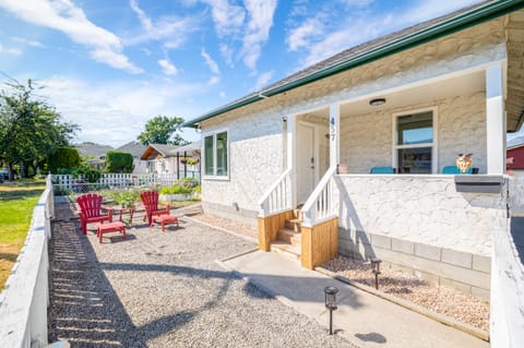 Fully fenced front yard with a cozy covered porch