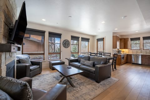 Living area offering a smart TV, cozy furnishings and a gas fireplace.