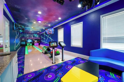 Enjoy a cosmic bowling experience in your private game room, complete with vibrant lighting and fun decor.