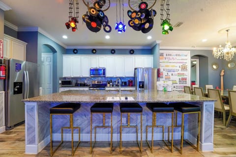 Enjoy cooking in this vibrant kitchen with a large island and unique decor, perfect for entertaining.