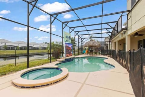 Relax in your private screened-in pool oasis with a hot tub and tiki-style seating, perfect for unwinding after a day of adventure.