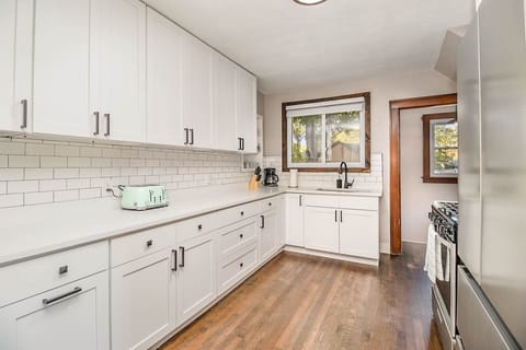 Cook meals in the newly updated kitchen. Kitchen includes nearly any basic cookware you would need: pots & pans, utensils, plates/bowls/cups, hand mixer, blender, mixing bowls, can opener, knives & cutting board, baking tins, glass casserole dishes.