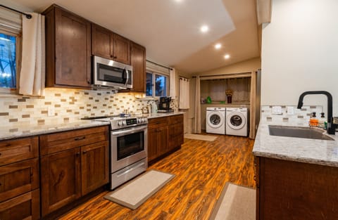 The modern kitchen is fully stocked with everything needed to cook
