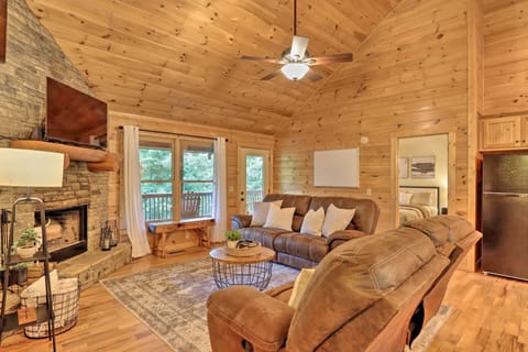 Cozy up in this family room with reclining sofas, a SMART TV, and a fireplace.