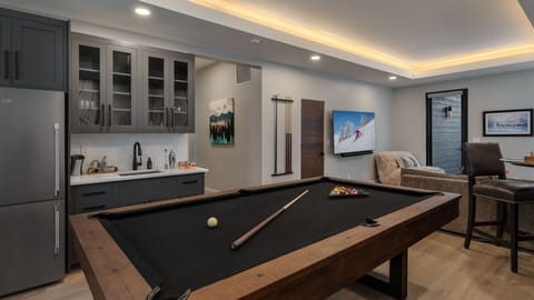 Family room with billiards, bar, and TV on lower level