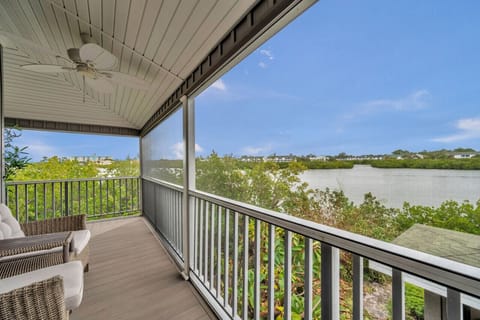 Covered balcony w/ seating, perfect for enjoying fresh air and peaceful moments.