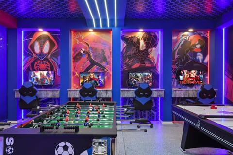 Ultimate superhero game room with foosball, air hockey & gaming stations galore.