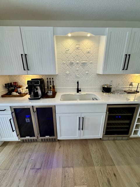 Fully stocked coffee & wet bar with espresso, wine fridge, and barware—perfect for morning lattes and evening cocktails.