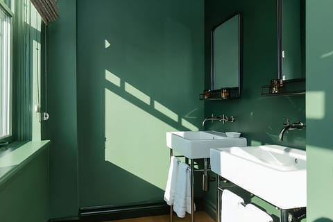 Refresh in a bright, airy bathroom with double sinks.