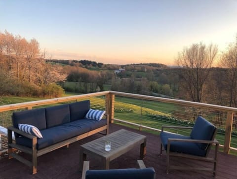 Huge wrap around deck, with seating, dining table, and grill. 