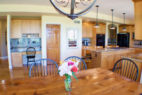 Large kitchen area. Desk, coffee station, bar area.