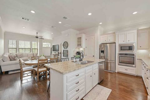 The kitchen island is large with ample serving space, stainless appliances and lots of supplies can be found throughout.