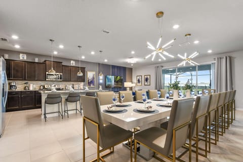 Spacious designer dining room with seating for 16 and statement modern lighting