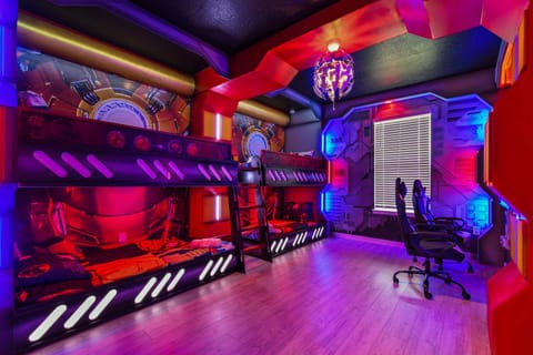 Epic superhero-themed room with bunk beds, LED lights, and gaming chairs