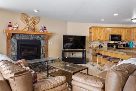 Enjoy relaxing in the living room on one of the two comfortable leather couches as you warm up by the lovely stone hearth electric fireplace and enjoy a movie night on the 58” TV.