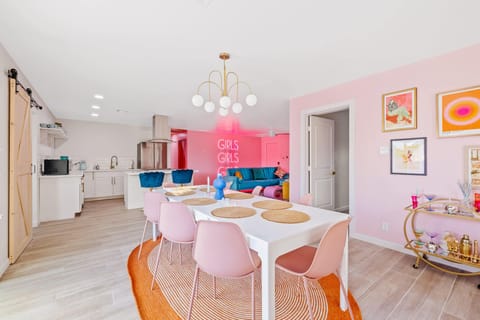 Stylish dining nook w/ a round table, soft tones, & cheerful accents.