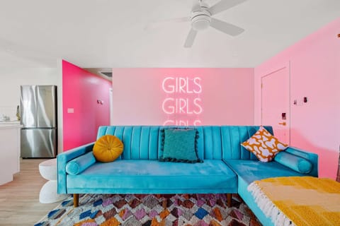 Inviting sitting area w/ soft seating, throw pillows, & warm tones.