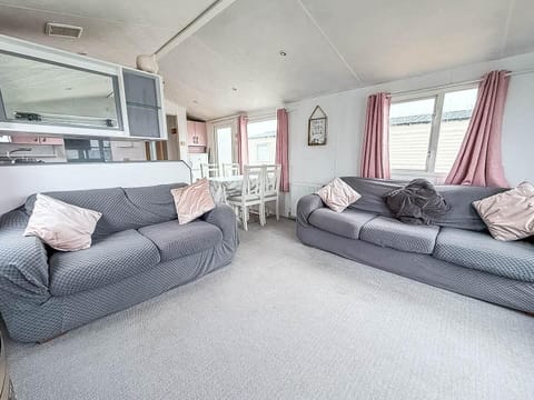 The holiday home living room features a fireplace that adds warmth and charm to the space.