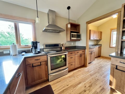 Stove, microwave, and pantry. 