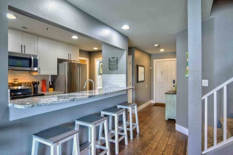 Bar seating next to dining area and kitchen 