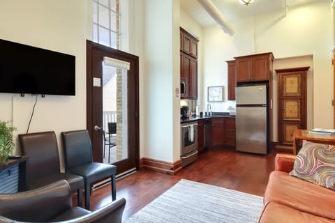 Living room and kitchen with the door to the covered piazza.