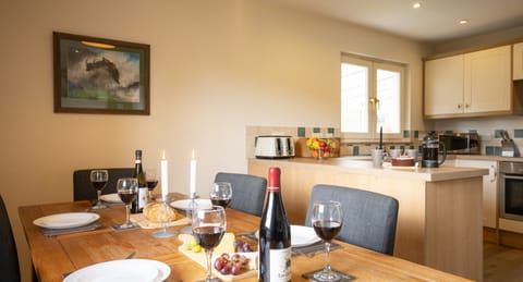 Salmon Run Lodge table set for dinner with kitchen behind