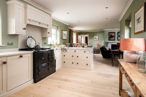 Risingham House - kitchen and dining area, leading through to the sitting room