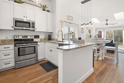 Enjoy this beautifully lit living space with 3 sky lights, 4 large windows and two sliding glass doors