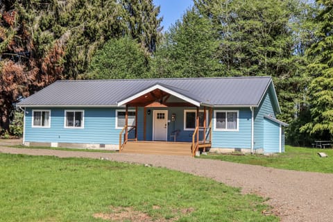 Front yard features a loop driveway and a large covered front porch. 