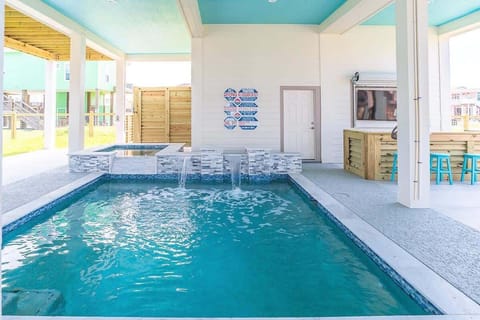 Hot tub with pool and waterfall feature