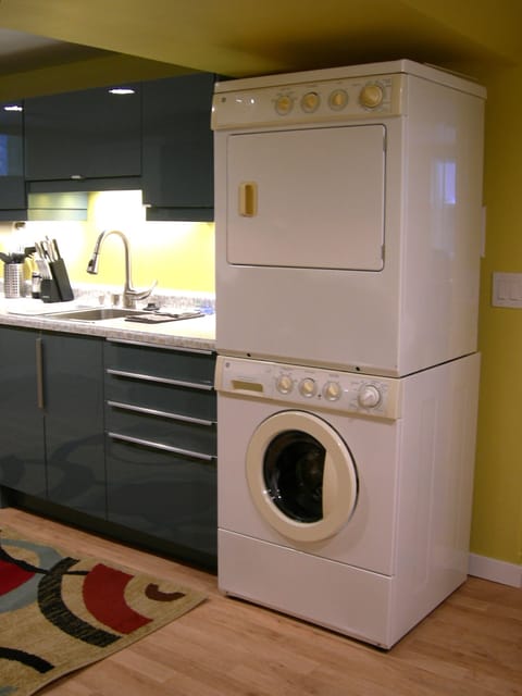 Stainless sink with disposal, free-to-use stacked washer and gas dryer.