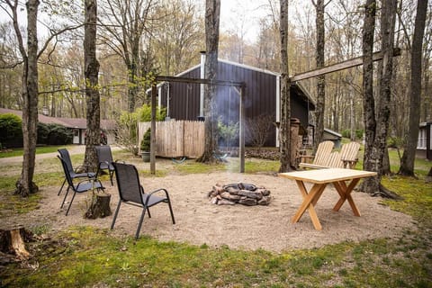 A cozy outdoor space with a firepit and chairs.