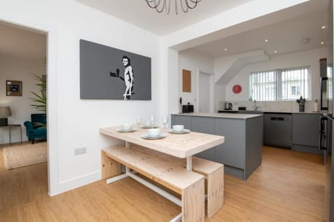  It is surrounded by a set of comfortable dining chairs.