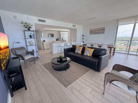 Bright living room with balcony access and city views.
