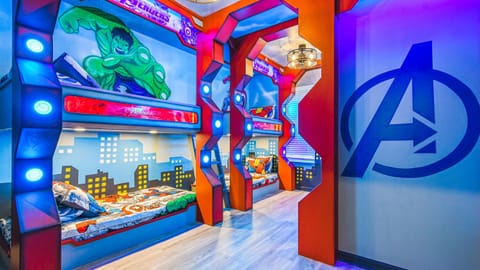 Epic Avengers-themed kids' bunk room with lights, murals, and hero bedding.