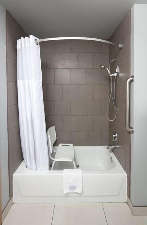 Bathroom with shower and tub. Basic toiletries and towels are provided