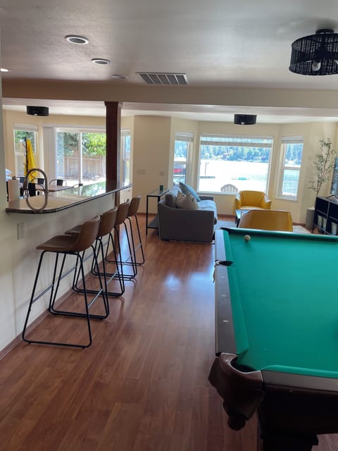 Downstairs pool table with family room off of kitchen with smart TV