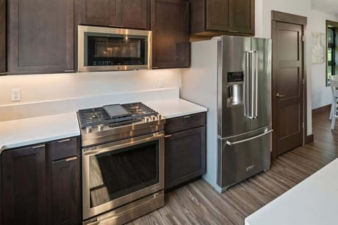 Fully appointed kitchen with gas range, pantry, and large fridge