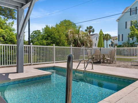 Dive into your private oasis where crystal-clear waters meet comfort. Lounge poolside while palm trees sway overhead in this tranquil backyard retreat.
