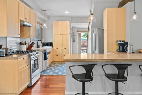 Amazing kitchen with high end Bosch appliances:  large refrigerator, gas stove, dishwasher, microwave, air fryer. 