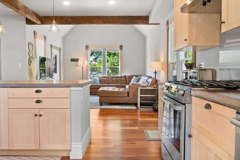 Living room opens to both the dining room and kitchen