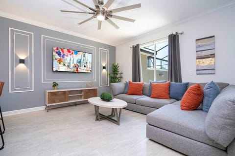 Step into this spacious, comfortable living area. The expansive room is adorned with tasteful decor, offering a blend of modern aesthetics and homey warmth. 