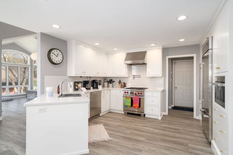 Cook with ease in this bright, fully-equipped kitchen featuring stainless steel appliances and ample counter space for meal prep.