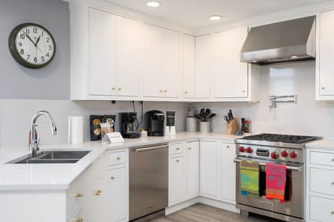 Cook your favorite meals in this bright, modern kitchen with premium appliances and coffee maker for perfect mornings.
